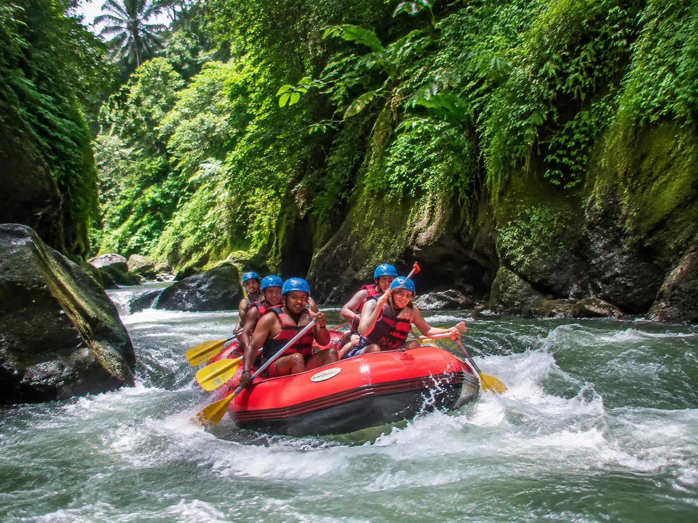 A raft on a green jungle river canyon
